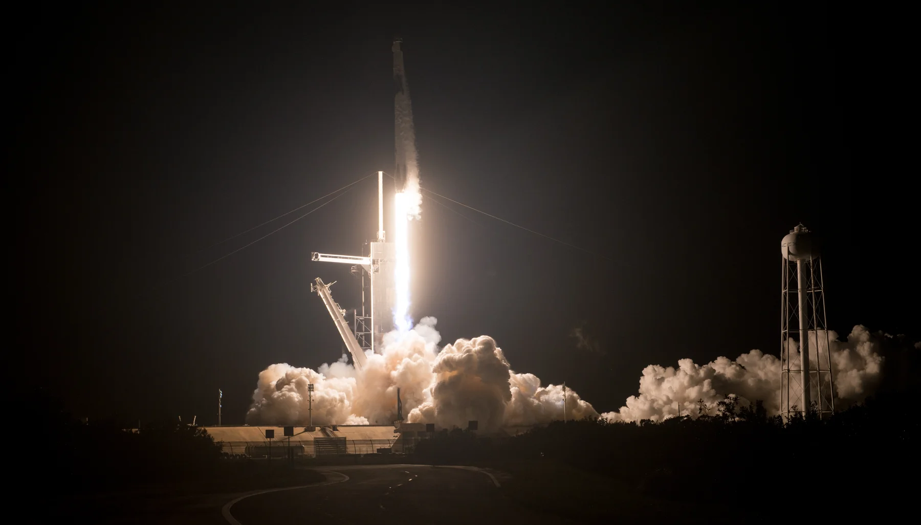 A Falcon 9 carrying the Crew-1 astronauts rises into the night above Kennedy Space Center.